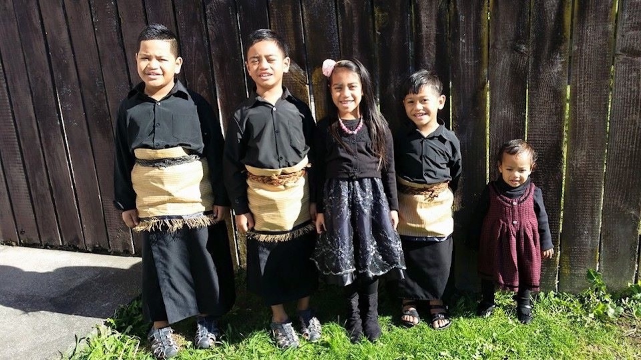 Five young Tongan children dressed for church in ta'ovala. .