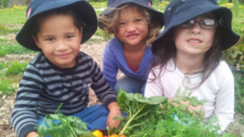 Three children in the vegetable garden..